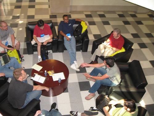 Overhead view of a group of developers having an impromptu open space discussion
